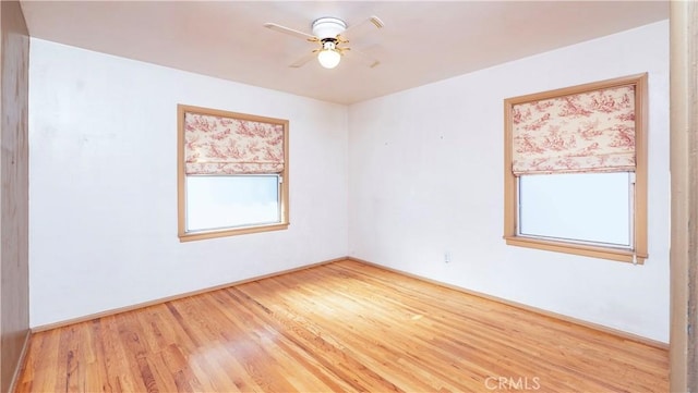 empty room featuring a ceiling fan and wood finished floors