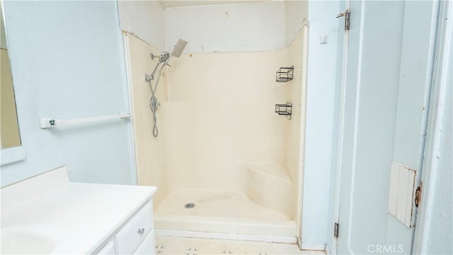 full bathroom featuring a shower stall and vanity