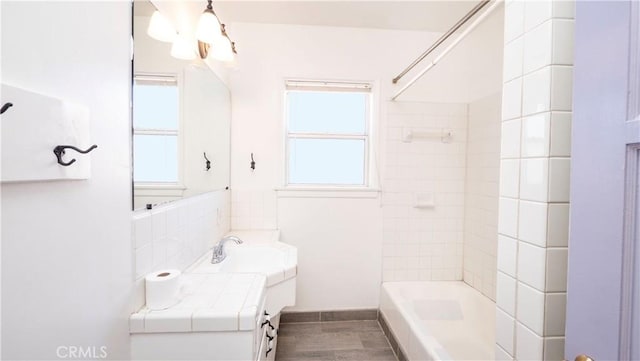 bathroom featuring bathing tub / shower combination and vanity