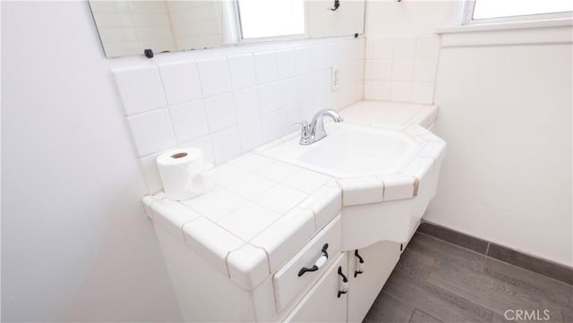 bathroom with wood finished floors and vanity