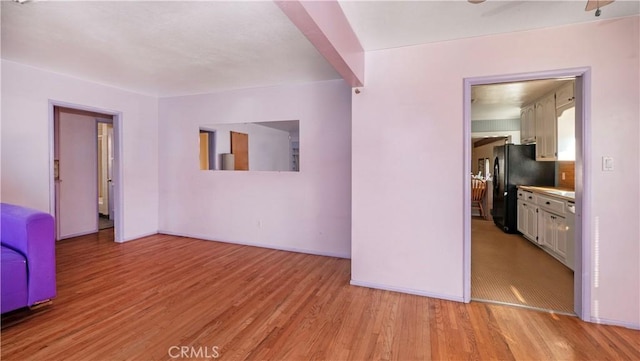 empty room featuring light wood-style floors and baseboards