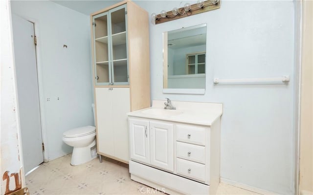 bathroom with vanity, toilet, and tile patterned floors