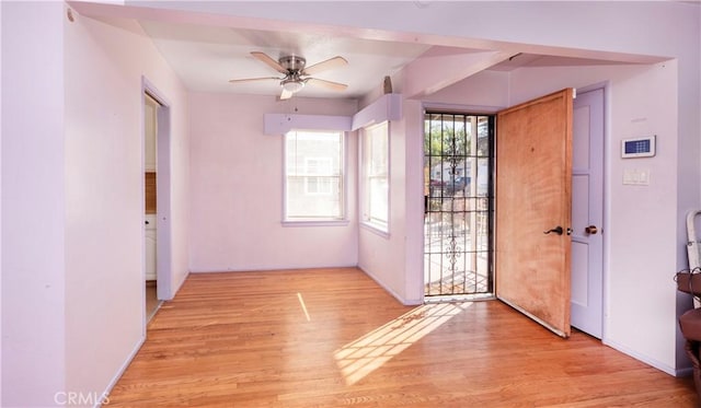 doorway to outside with light wood-type flooring and ceiling fan