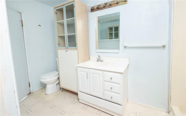 bathroom featuring toilet, vanity, and tile patterned floors