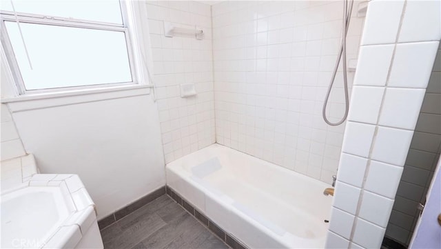 bathroom featuring shower / bath combination and wood finished floors