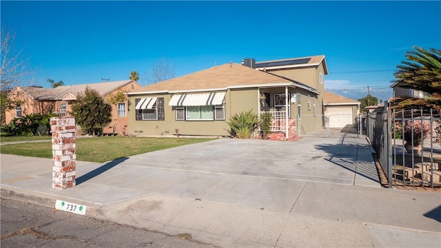 view of front facade with a front lawn, fence, a gate, and stucco siding