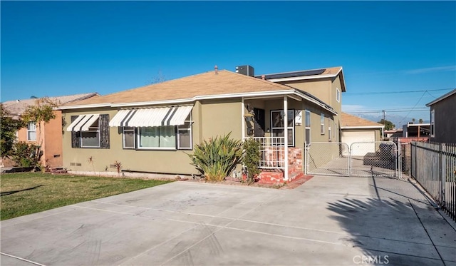 bungalow with a gate, fence, and stucco siding