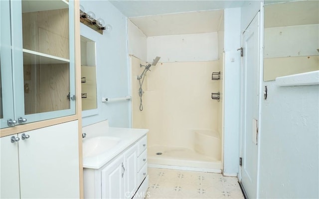 bathroom with a shower stall, vanity, and tile patterned floors