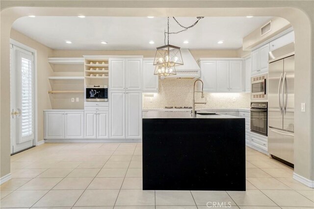 26803 Brookhollow Dr, Valencia, CA 91355 - kitchen featuring built in appliances, arched walkways, a sink, decorative backsplash, and light tile patterned flooring