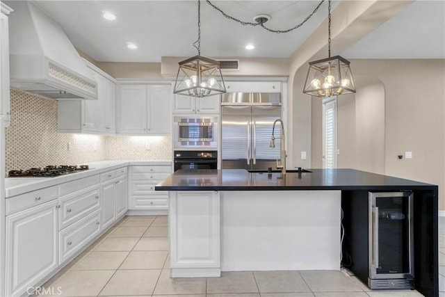 26803 Brookhollow Dr, Valencia, CA 91355 - kitchen featuring built in appliances, a chandelier, custom range hood, wine cooler, and a sink