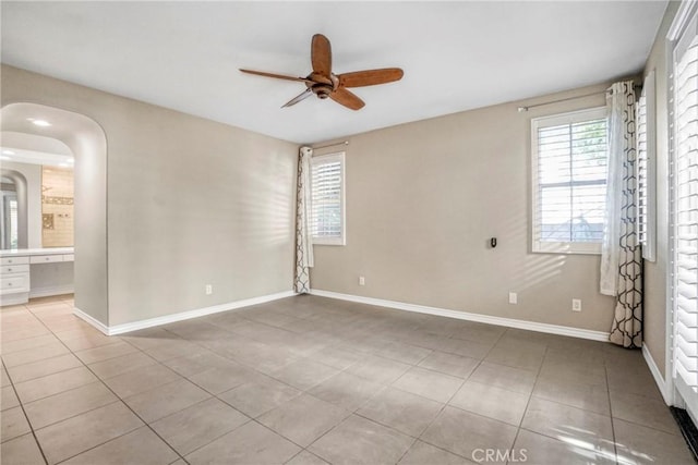 26803 Brookhollow Dr, Valencia, CA 91355 - unfurnished room featuring a ceiling fan, tile patterned floors, baseboards, and arched walkways