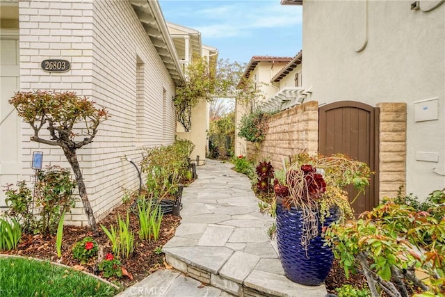 view of home's exterior featuring fence and stucco siding