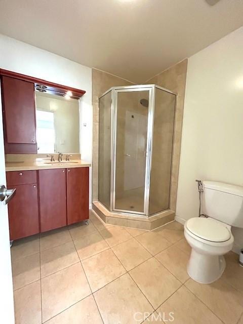 bathroom with a shower stall, vanity, and tile patterned floors