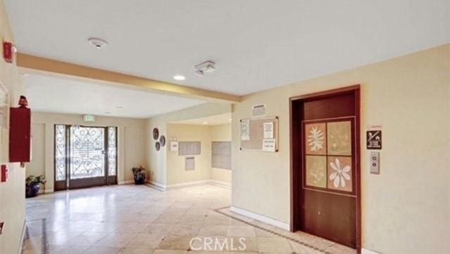 interior space with beamed ceiling, recessed lighting, and baseboards