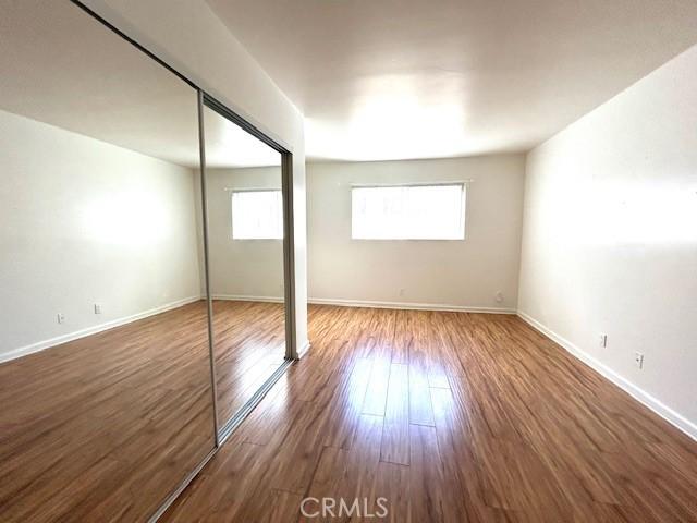 interior space featuring a closet, baseboards, and wood finished floors