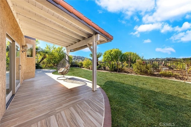 wooden deck with a yard and fence