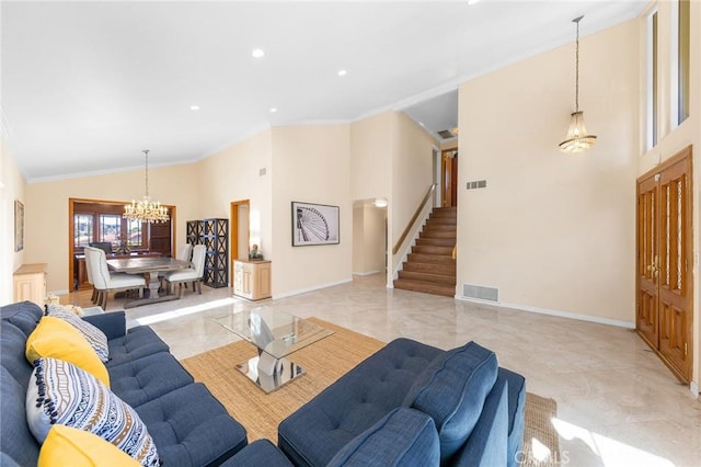 living area featuring stairs, baseboards, visible vents, and an inviting chandelier