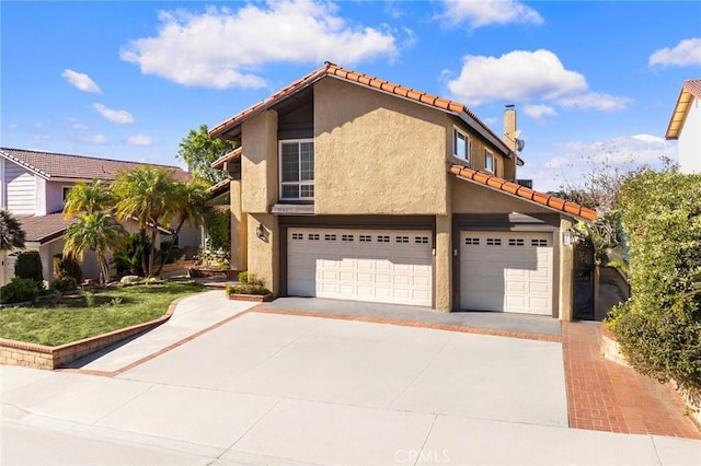 view of front of property featuring an attached garage, concrete driveway, a tiled roof, stucco siding, and a chimney