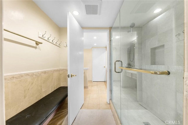 full bath featuring tile walls, recessed lighting, visible vents, a shower stall, and tile patterned floors