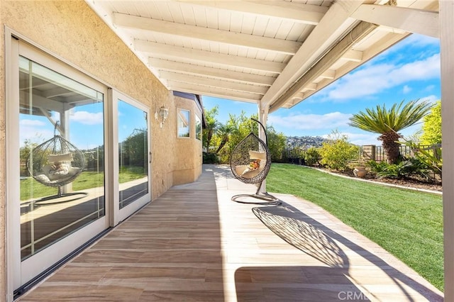 wooden terrace with a lawn