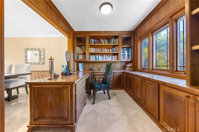 office space with ornamental molding and built in study area