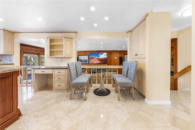 kitchen with recessed lighting, marble finish floor, ornamental molding, open shelves, and built in desk