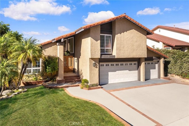 view of front of house with stucco siding, a tiled roof, and driveway