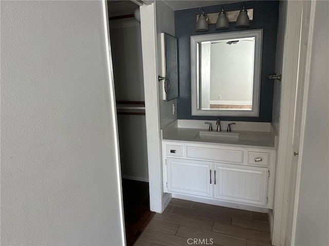 bathroom with wood finish floors and vanity