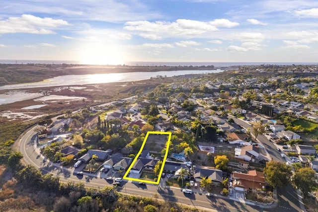 birds eye view of property with a water view and a residential view