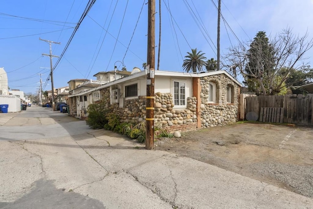 view of property exterior with fence and stucco siding