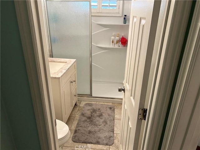 full bath with tile patterned floors, a shower stall, vanity, and toilet