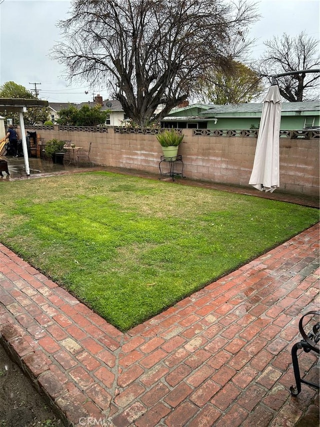 view of yard featuring a patio and a fenced backyard