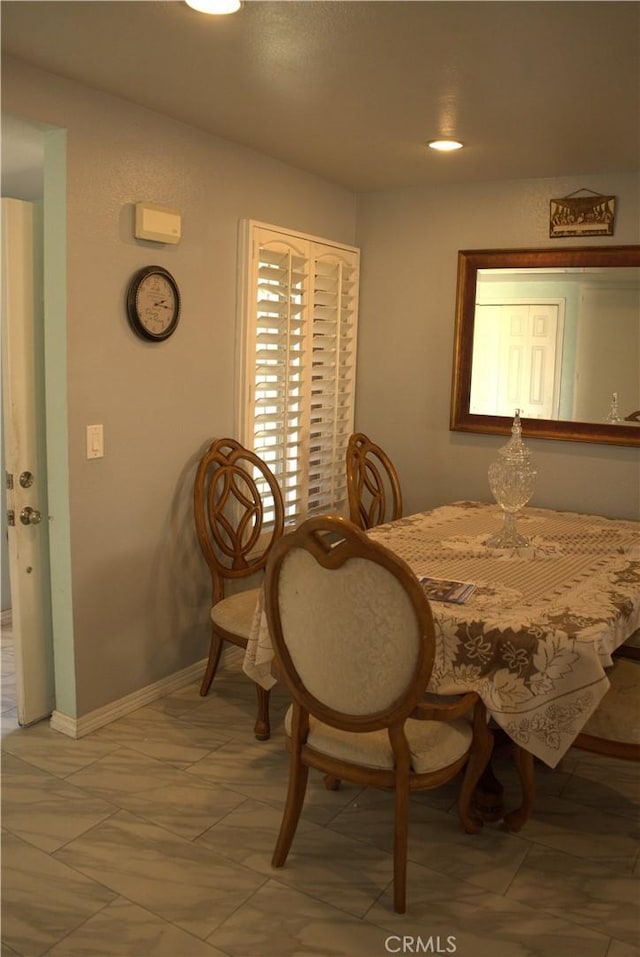 dining area featuring baseboards