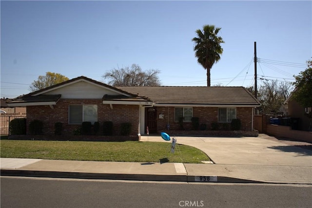 ranch-style house with brick siding, a front yard, and fence