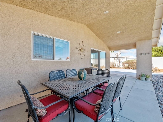 view of patio featuring outdoor dining area and fence