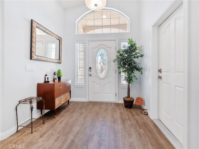 entryway with wood finished floors and baseboards