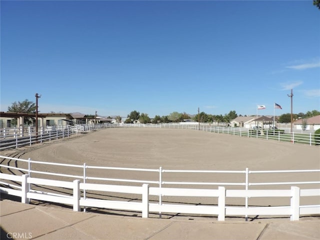 view of property's community with an enclosed area and a rural view