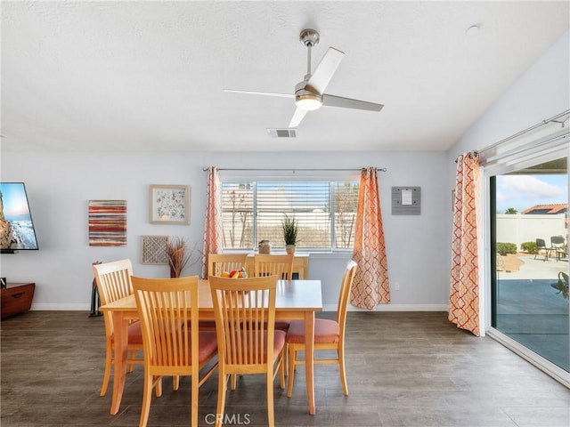 dining area with baseboards, visible vents, ceiling fan, and wood finished floors