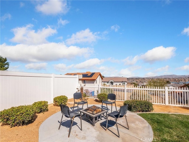 view of patio / terrace with a fenced backyard and a fire pit