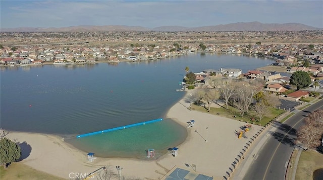 drone / aerial view with a water and mountain view and a residential view