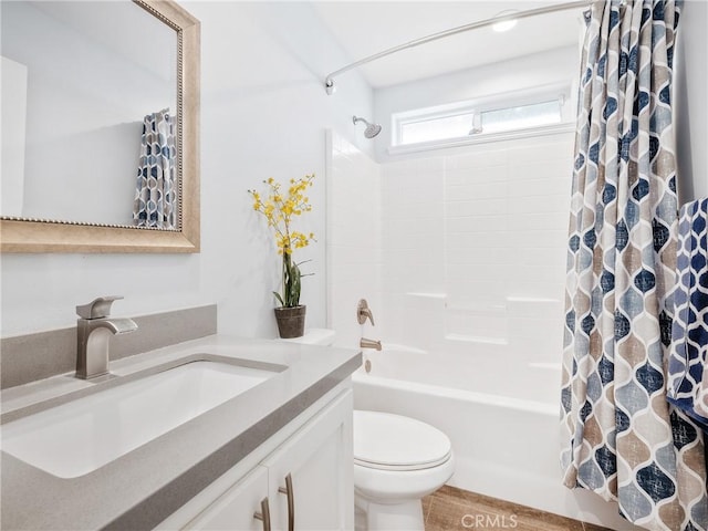 bathroom with toilet, shower / bath combo, and vanity