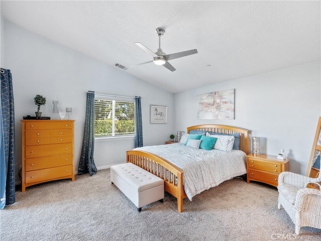 carpeted bedroom with vaulted ceiling, visible vents, and a ceiling fan