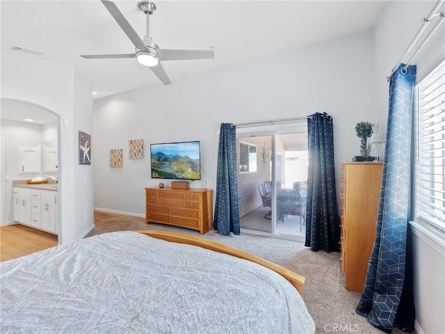 bedroom with multiple windows, visible vents, and arched walkways