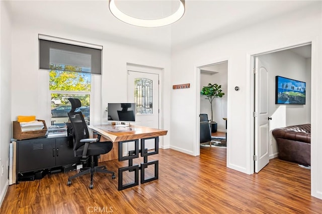 office area featuring baseboards and wood finished floors