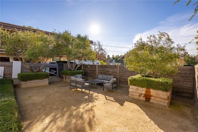 view of yard featuring a patio area, a fenced backyard, and an outdoor hangout area