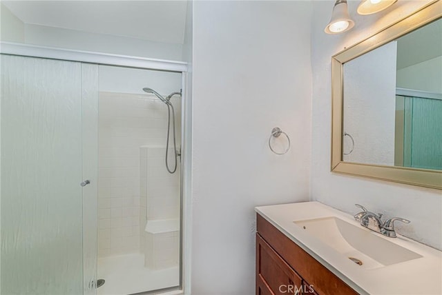 full bathroom with a stall shower and vanity