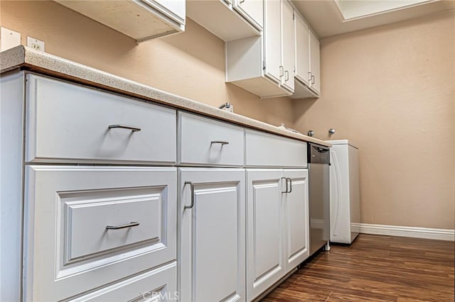 kitchen featuring light countertops, white cabinetry, dark wood finished floors, and baseboards