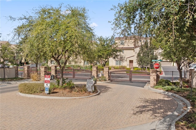 view of home's community featuring fence and a gate