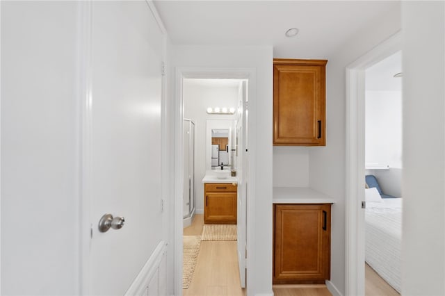 hall featuring light wood finished floors and visible vents