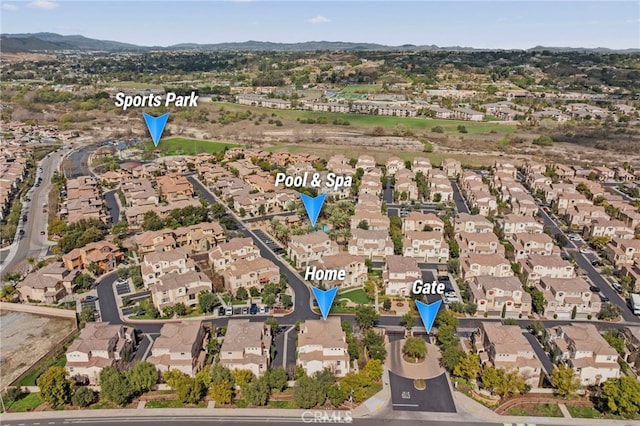 birds eye view of property featuring a mountain view and a residential view